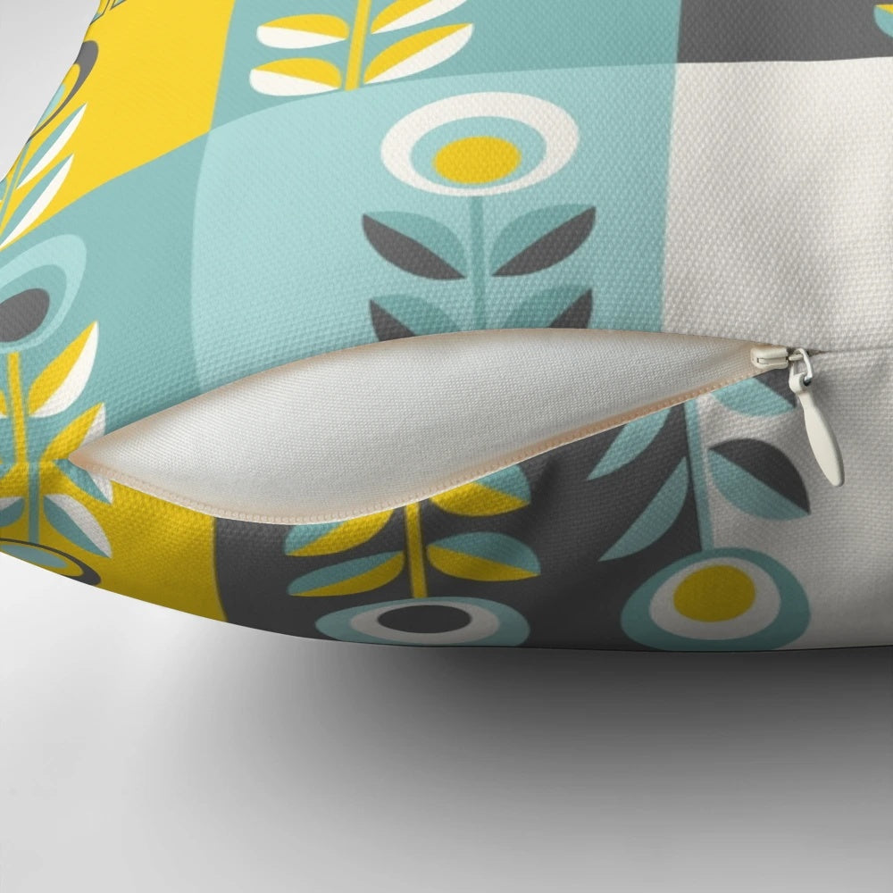 Scandinavian-inspired floral pattern pillow in shades of yellow, gray, and teal