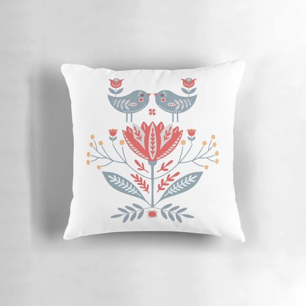 Decorative throw pillow featuring Scandinavian-inspired folk art design with birds and flowers