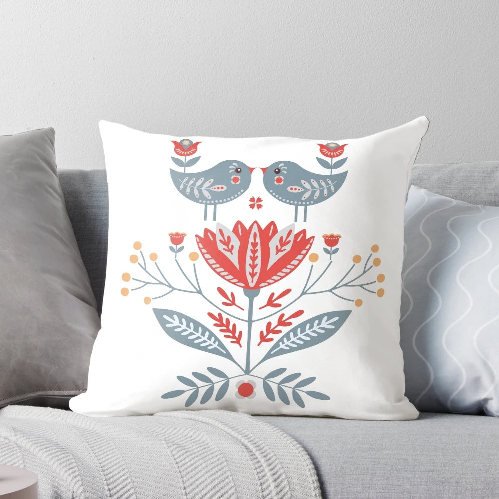 Decorative throw pillow featuring Scandinavian-inspired folk art design with birds and flowers