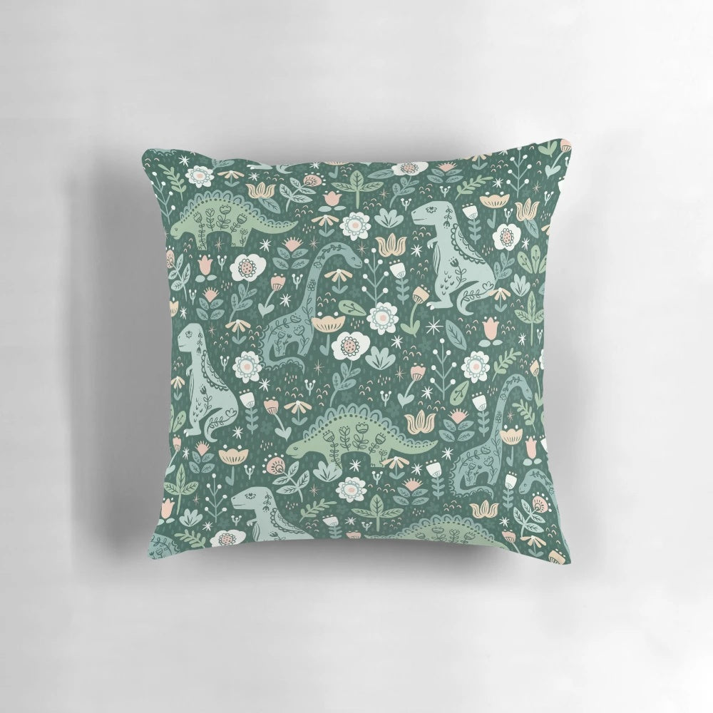 A folk floral dinosaur pattern pillows featuring a T-Rex, Brontosaurus, and Stegosaurus in a scandinavian-style design.