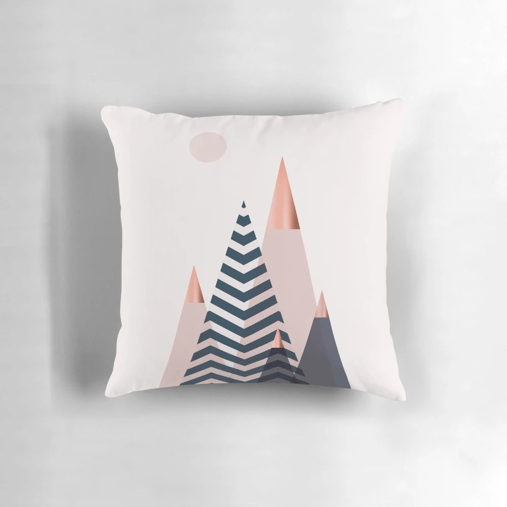 Scandinavian mountain peaks decorative throw pillow featuring a blush, navy, and blue color palette