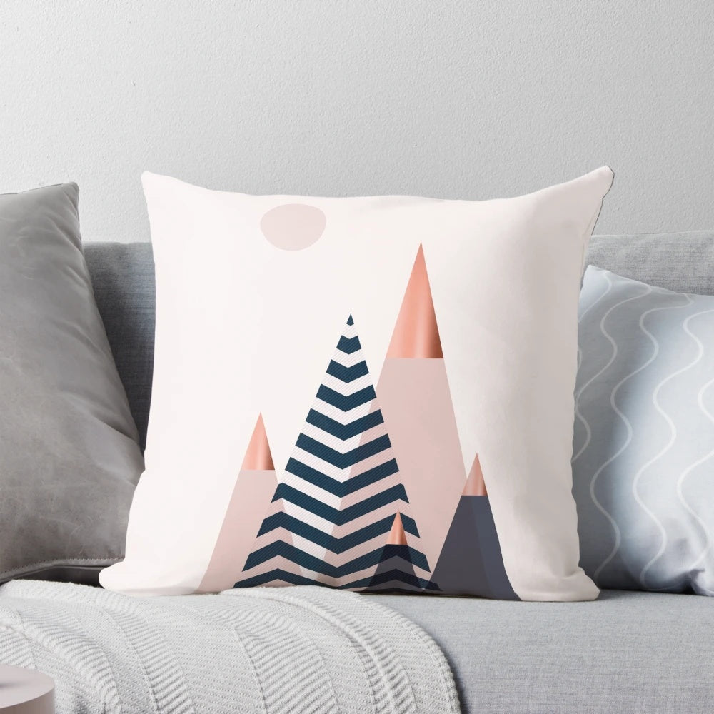 Scandinavian mountain peaks decorative throw pillow featuring a blush, navy, and blue color palette