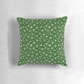 A white and green Scandinavian-style pillow with snowflake design, perfect for winter home decor.