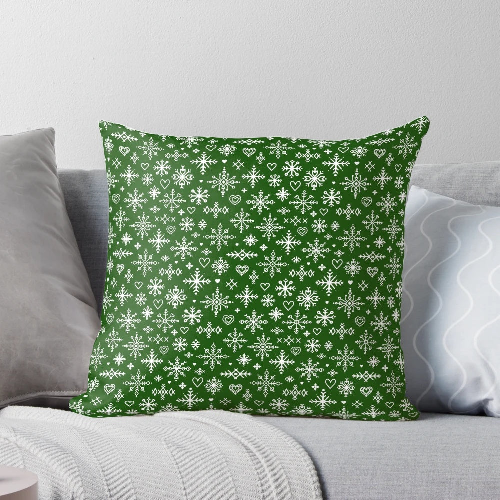 A white and green Scandinavian-style pillow with snowflake design, perfect for winter home decor.