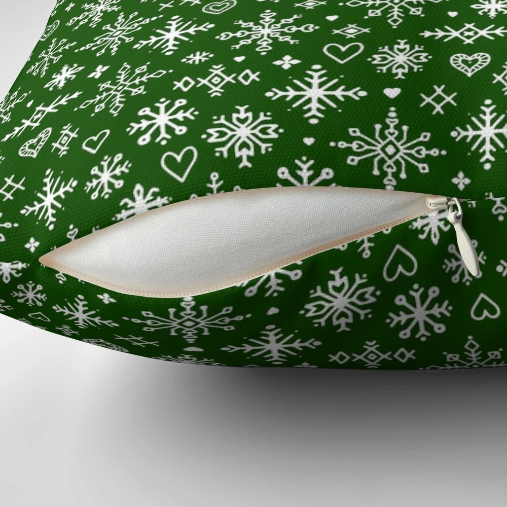 A white and green Scandinavian-style pillow with snowflake design, perfect for winter home decor.