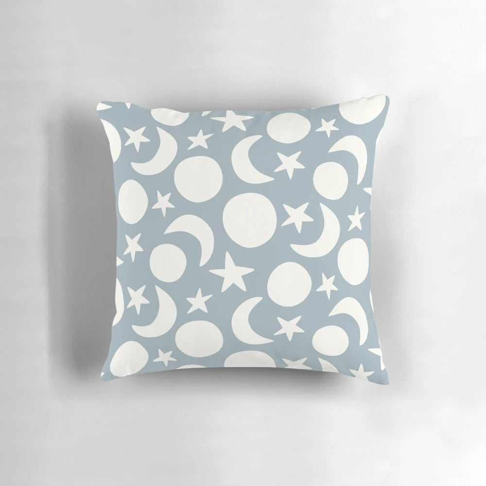 Cream and blue decorative pillow with a minimalist moon and stars pattern, perfect for Scandinavian-inspired home decor.