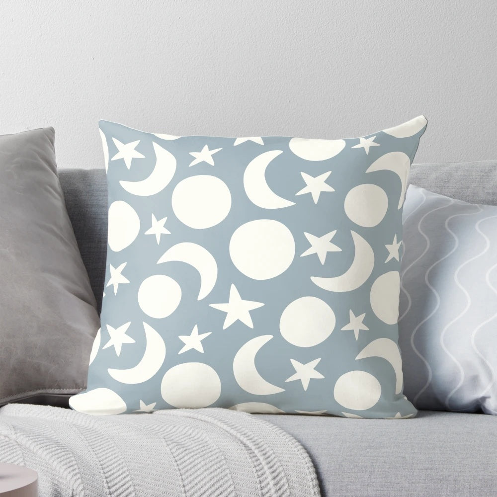 Cream and blue decorative pillow with a minimalist moon and stars pattern, perfect for Scandinavian-inspired home decor.
