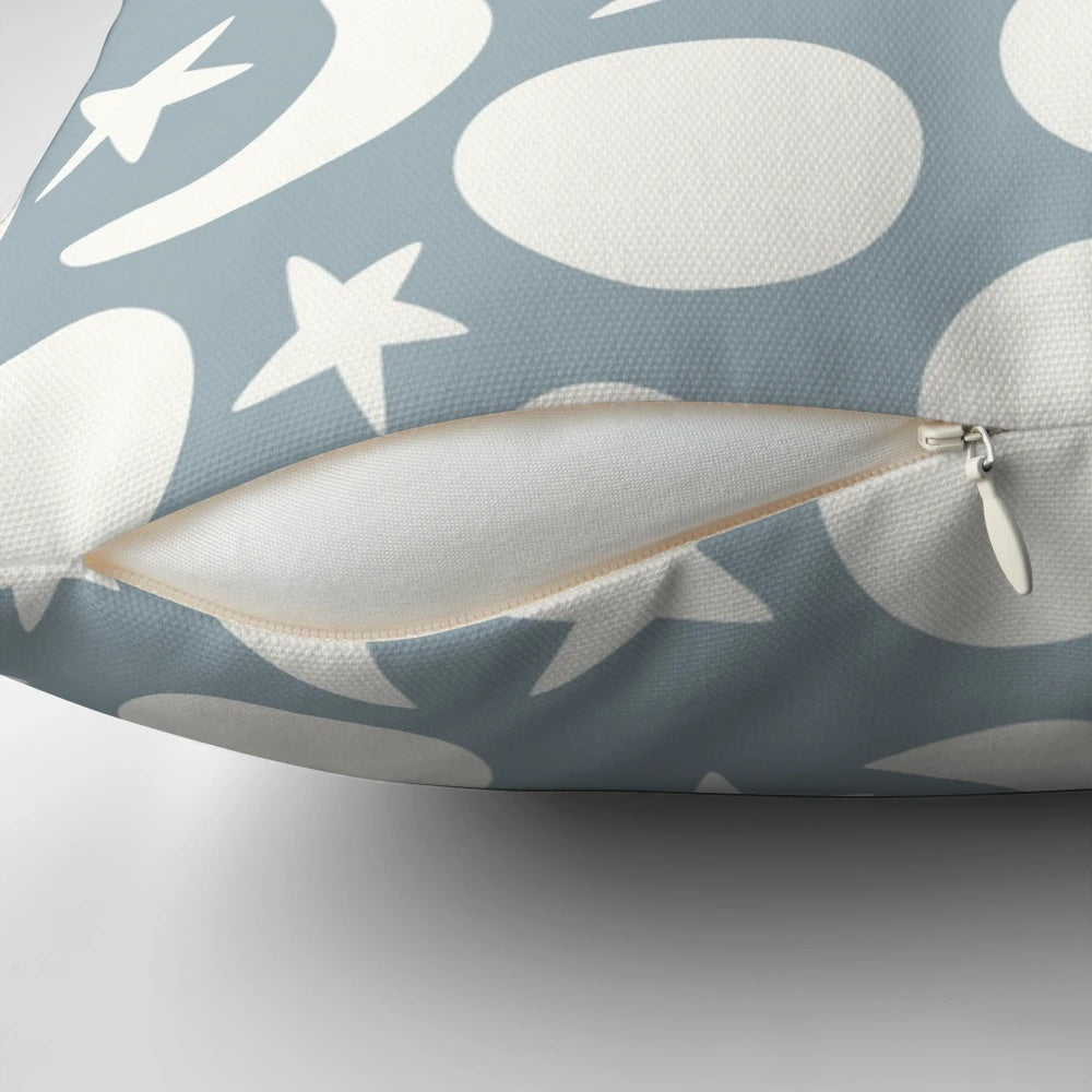 Cream and blue decorative pillow with a minimalist moon and stars pattern, perfect for Scandinavian-inspired home decor.