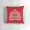 Closeup of a white Scandinavian-style Christmas tree printed on a red throw pillow, with snowflakes and floral accents.