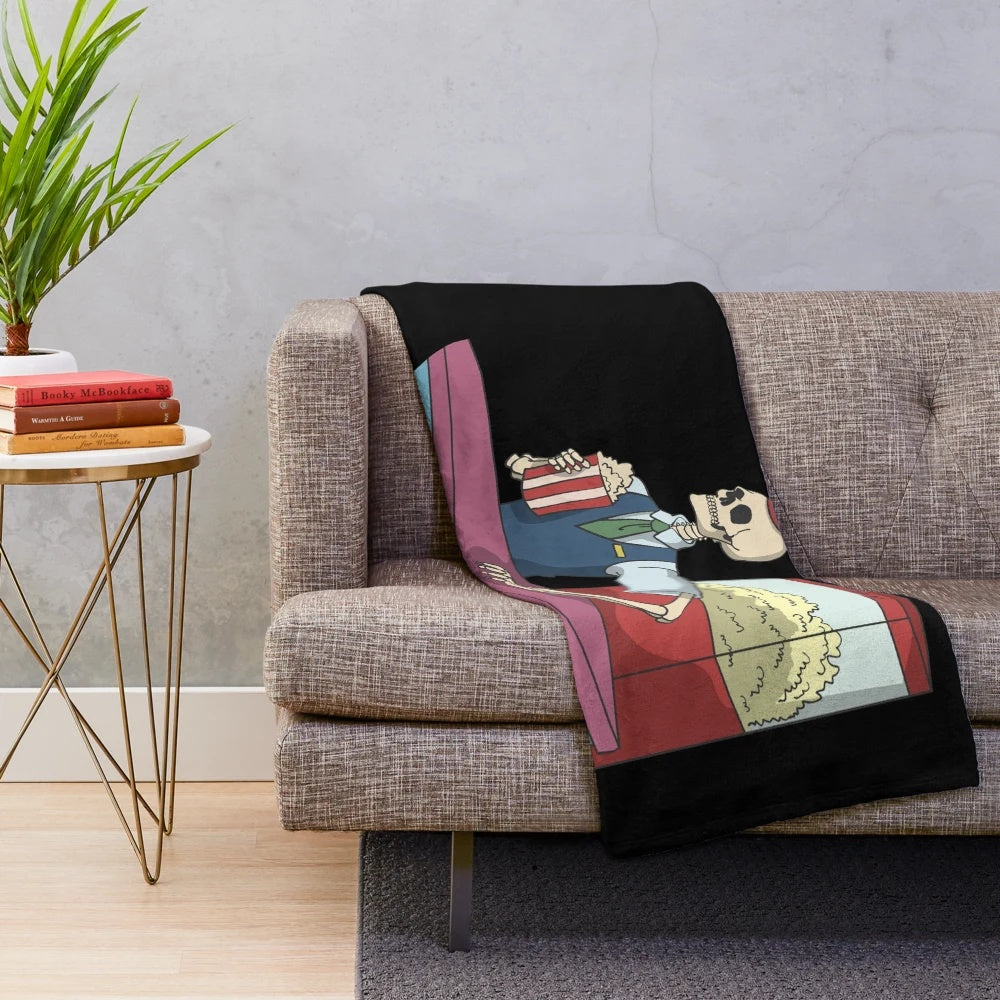 Spooky skeleton cinema plush blanket with movie popcorn and horror theme