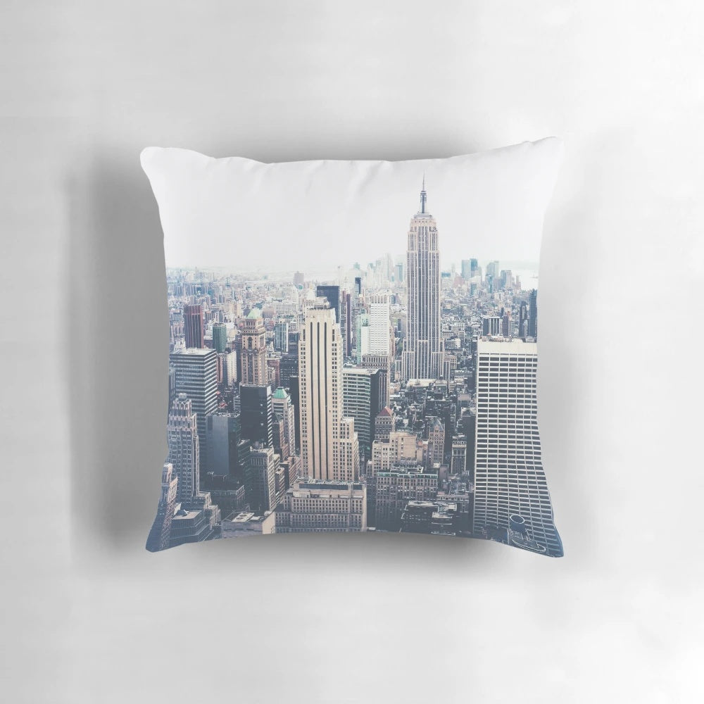 Decorative throw pillow featuring a cityscape of the New York City skyline with the iconic Empire State Building on a foggy day