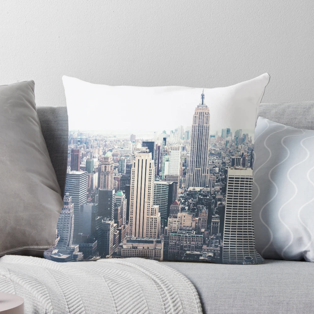 Decorative throw pillow featuring a cityscape of the New York City skyline with the iconic Empire State Building on a foggy day