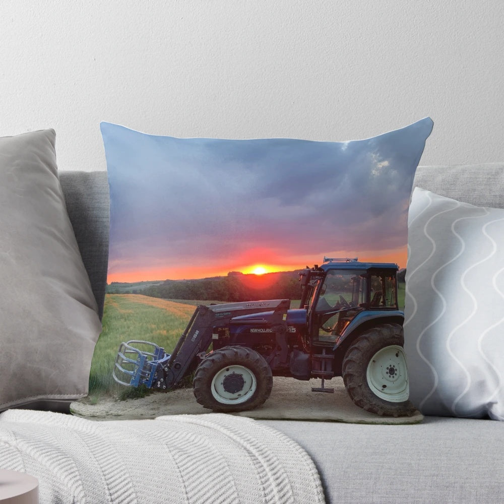 A vibrant sunset casts a warm glow over a New Holland tractor in a pastoral landscape.