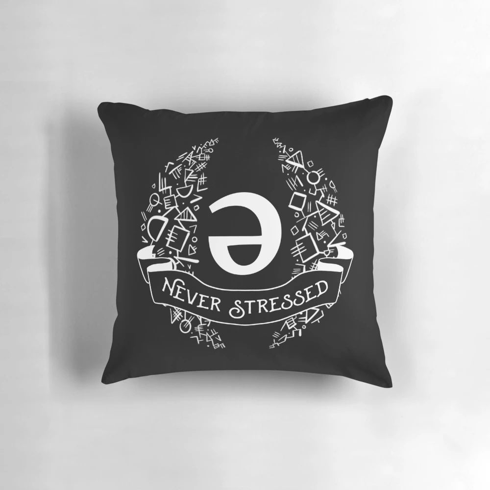 White geometric throw pillow with the word "schwa" printed on it, an important linguistic concept.