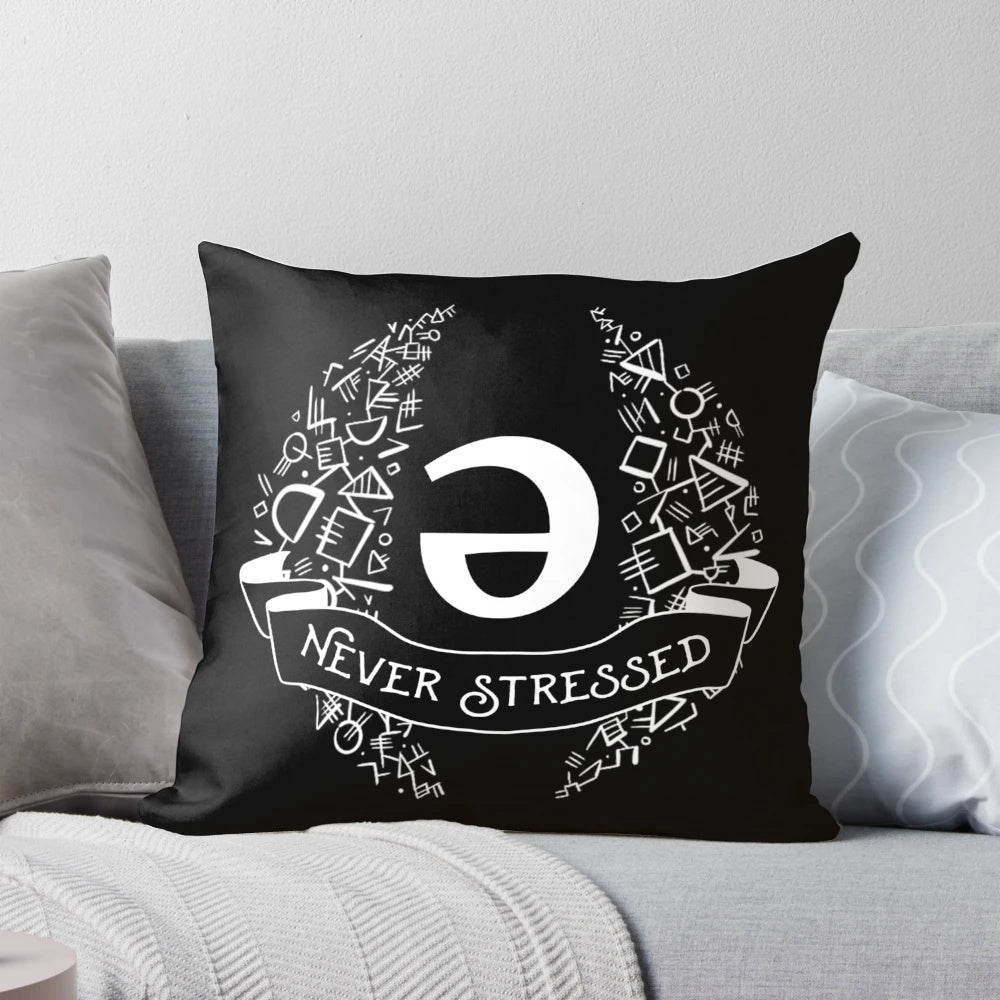 White geometric throw pillow with the word "schwa" printed on it, an important linguistic concept.