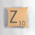 A white throw pillow with a large uppercase letter 'Z' in a classic scrabble font