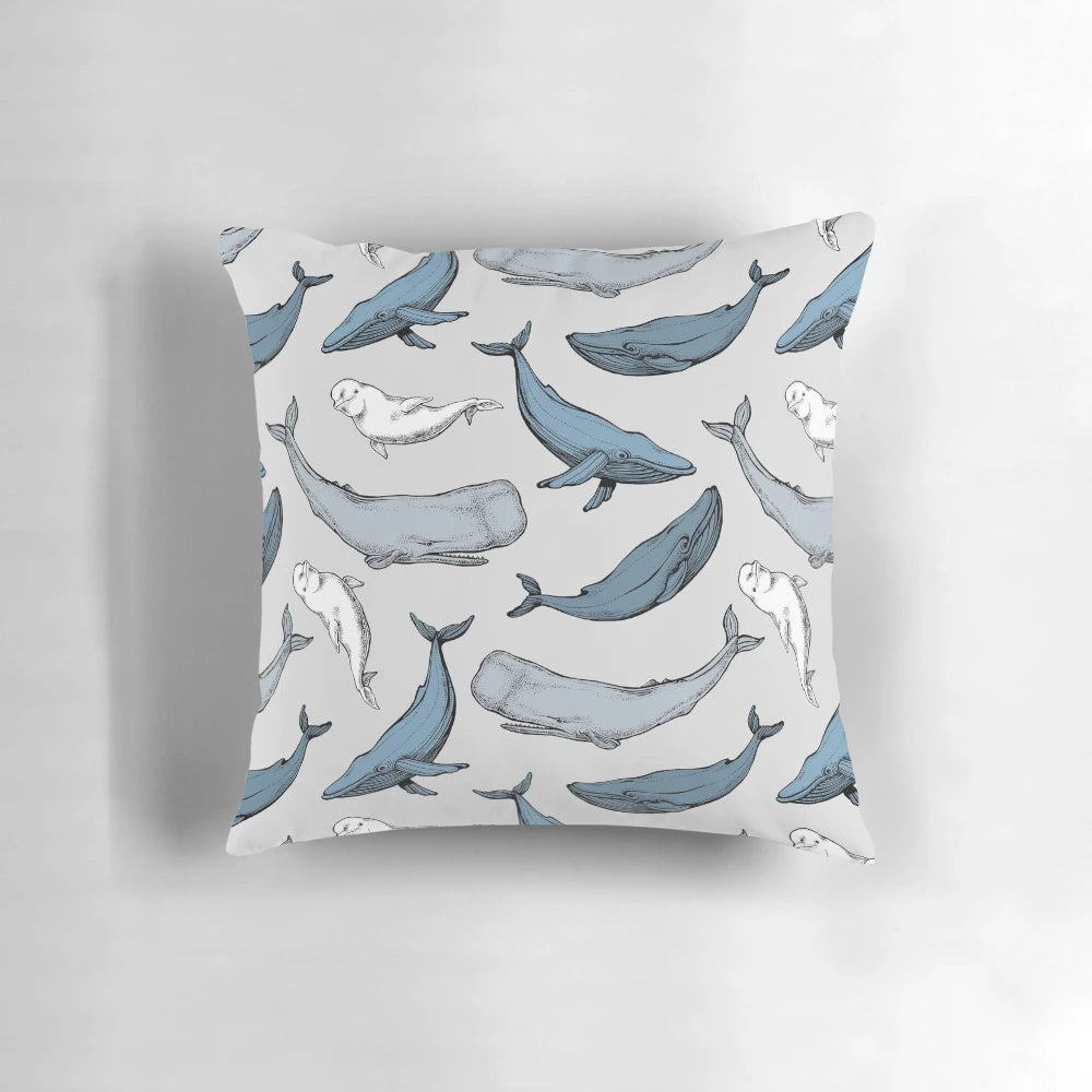 Decorative throw pillow with a seamless pattern of whales and other marine mammals.
