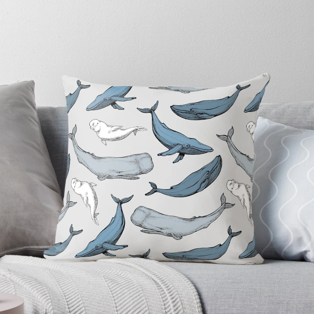 Decorative throw pillow with a seamless pattern of whales and other marine mammals.