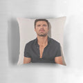 Sebastian Stan wearing a black shirt printed on a pillow