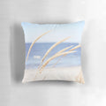 Blue and white beach grass photography printed on a cozy pillow