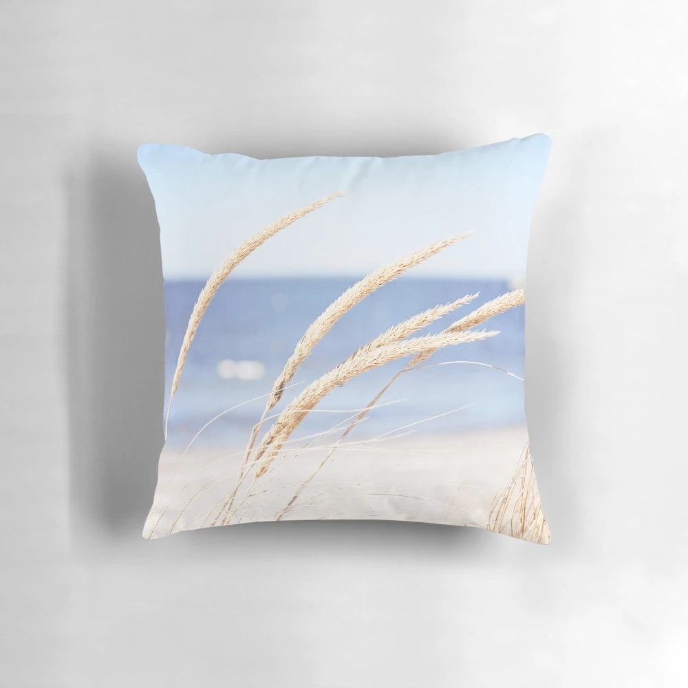 Blue and white beach grass photography printed on a cozy pillow