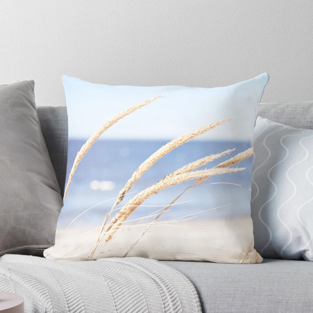 Blue and white beach grass photography printed on a cozy pillow