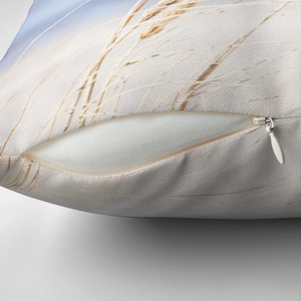 Blue and white beach grass photography printed on a cozy pillow