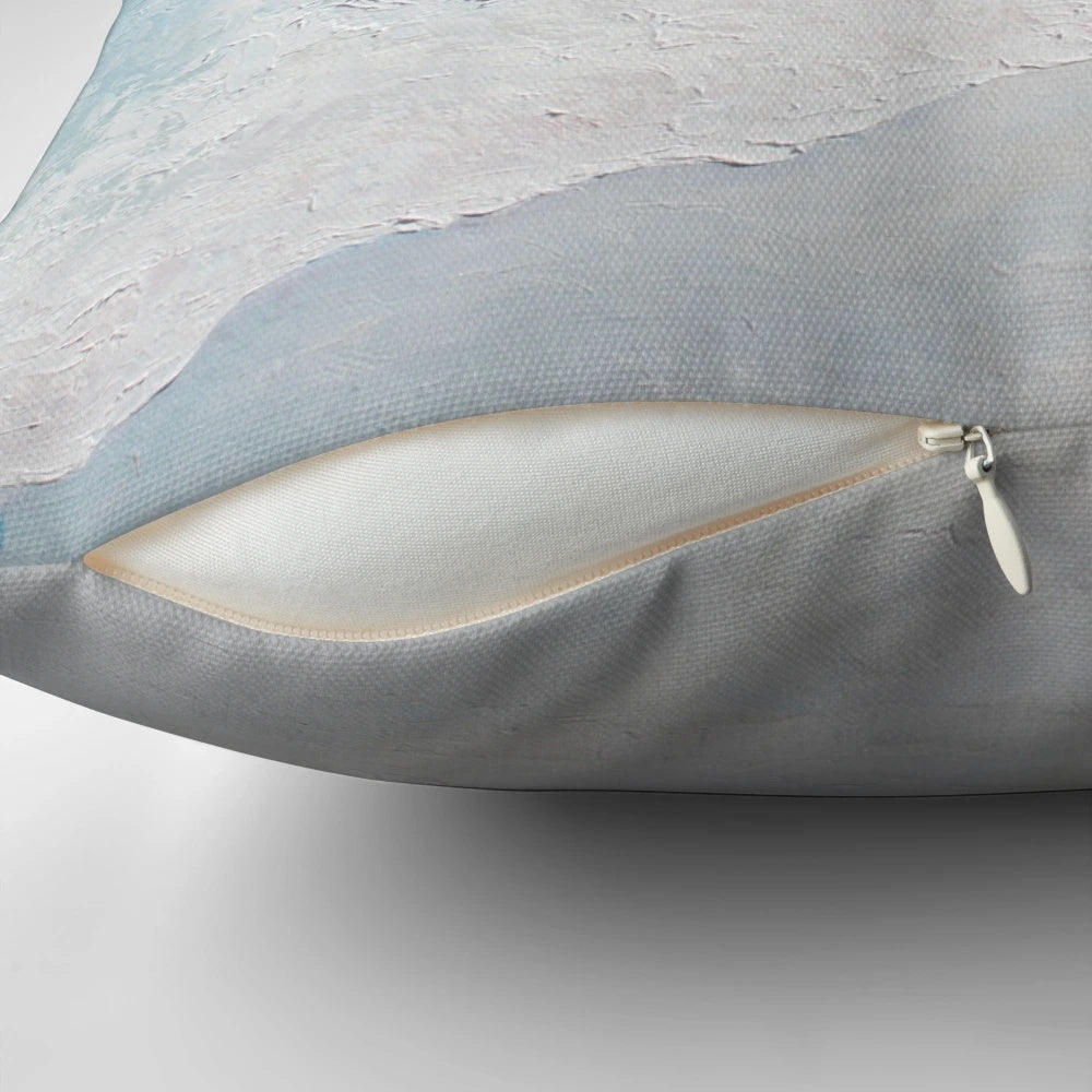 Decorative beach pillow featuring a vibrant seascape painting of crashing waves and a sandy shore.