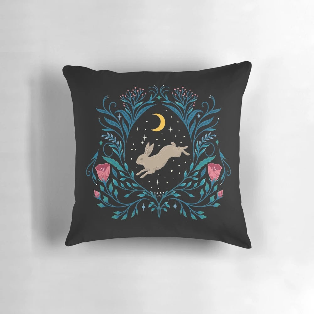 A beautiful black and white botanical throw pillow featuring a full moon and nighttime garden scene.