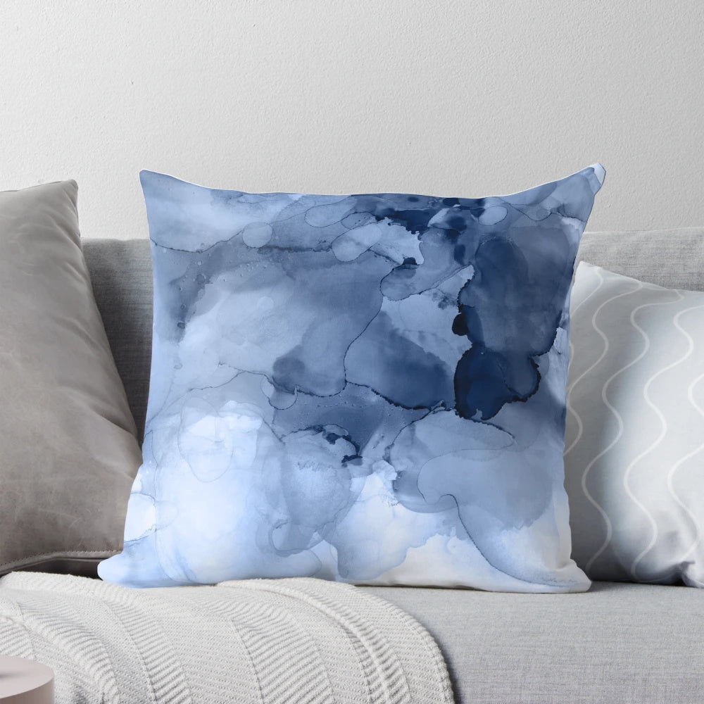 Stormy weather-inspired abstract blue and white pillow with fluid ink and textural elements