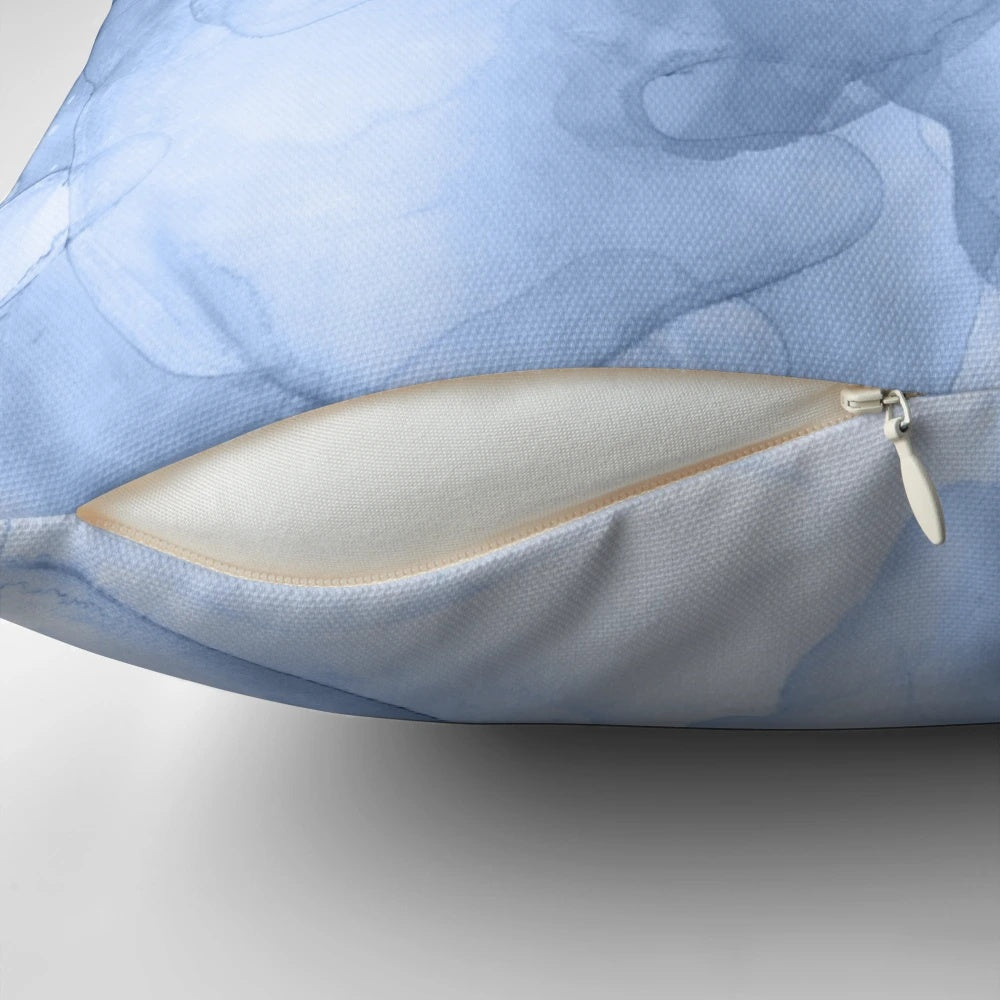 Stormy weather-inspired abstract blue and white pillow with fluid ink and textural elements