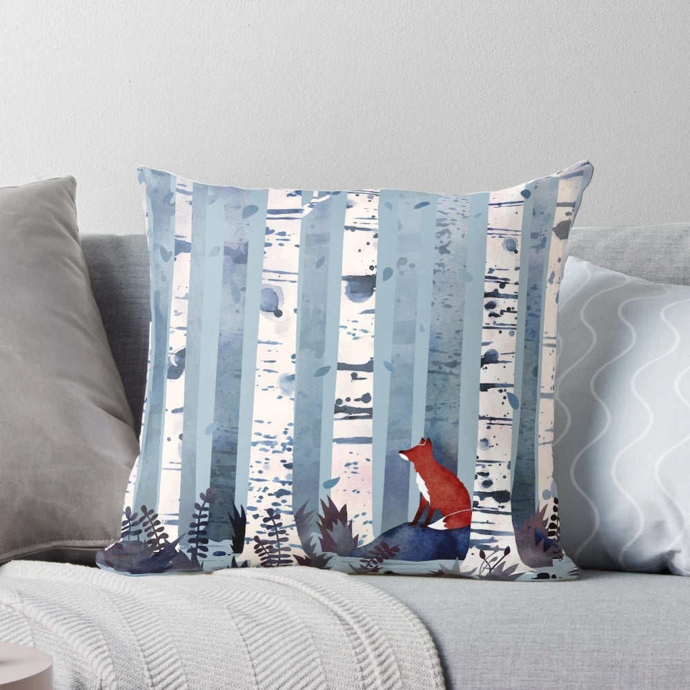 Blue and white watercolor painting of birch trees in a forest, featured on a decorative throw pillow.