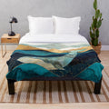 Blue whale plush blanket with watercolor and abstract ocean design