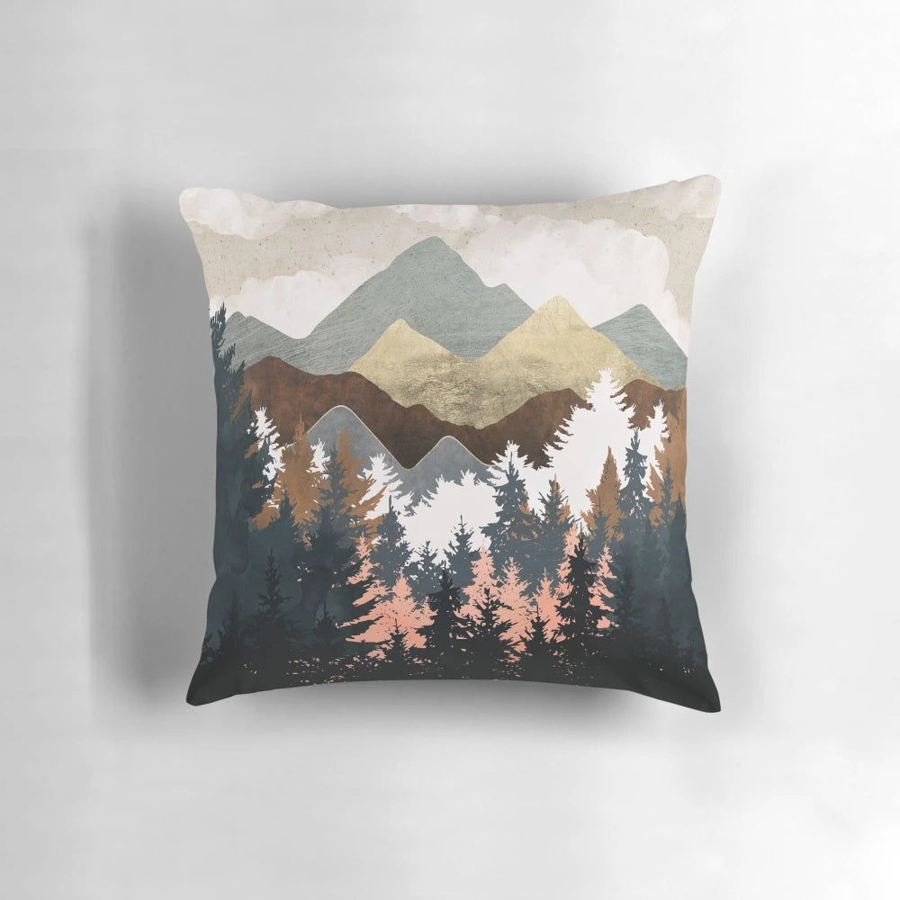 Decorative forest-themed pillow with a scenic landscape design