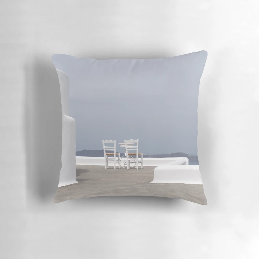 Calming blue and white pillow with a scenic seaside view, perfect for a tranquil island getaway.