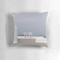 Calming blue and white pillow with a scenic seaside view, perfect for a tranquil island getaway.