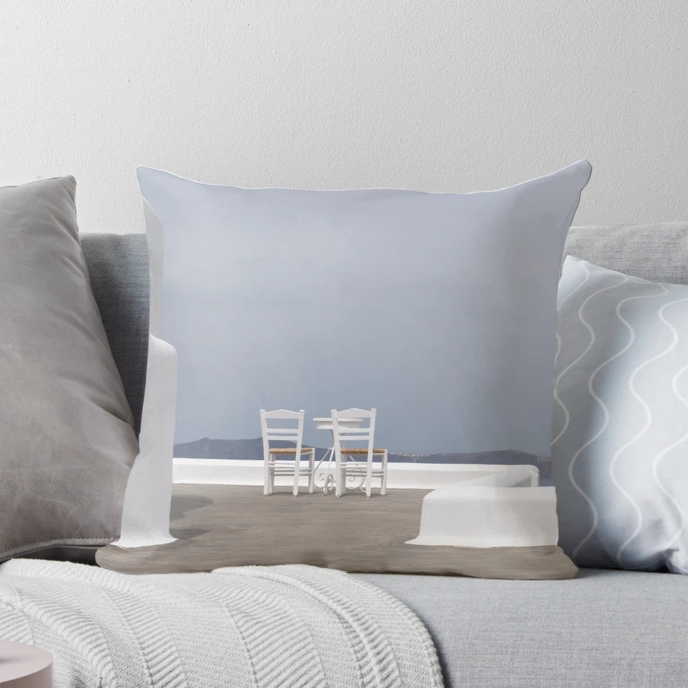 Calming blue and white pillow with a scenic seaside view, perfect for a tranquil island getaway.