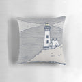 A decorative lighthouse-themed pillow in shades of blue and gray, perfect for coastal-inspired home decor.