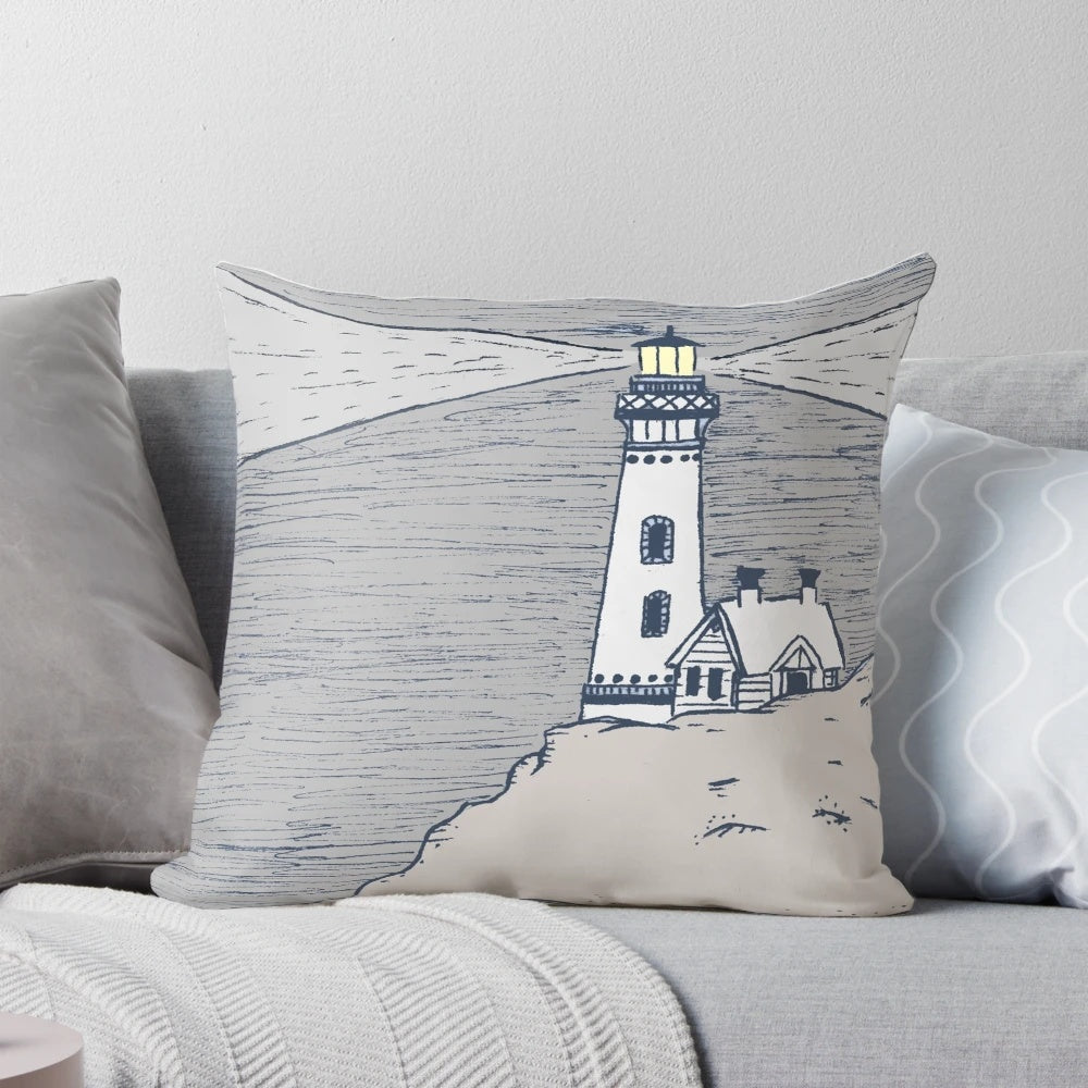 A decorative lighthouse-themed pillow in shades of blue and gray, perfect for coastal-inspired home decor.