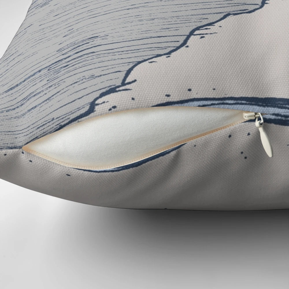 A decorative lighthouse-themed pillow in shades of blue and gray, perfect for coastal-inspired home decor.