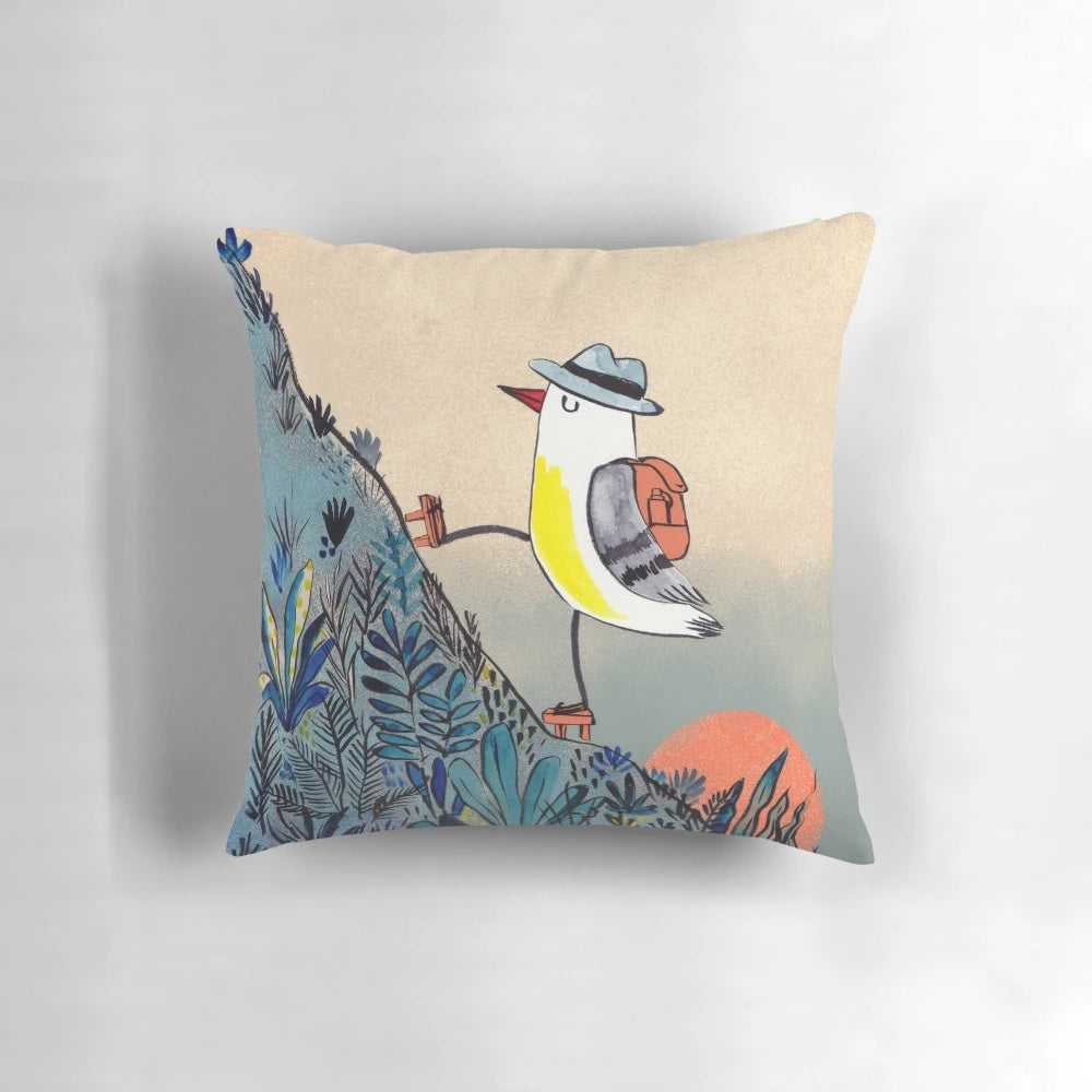 Pillow featuring a detailed illustration of a bird hiking in the mountains at sunrise