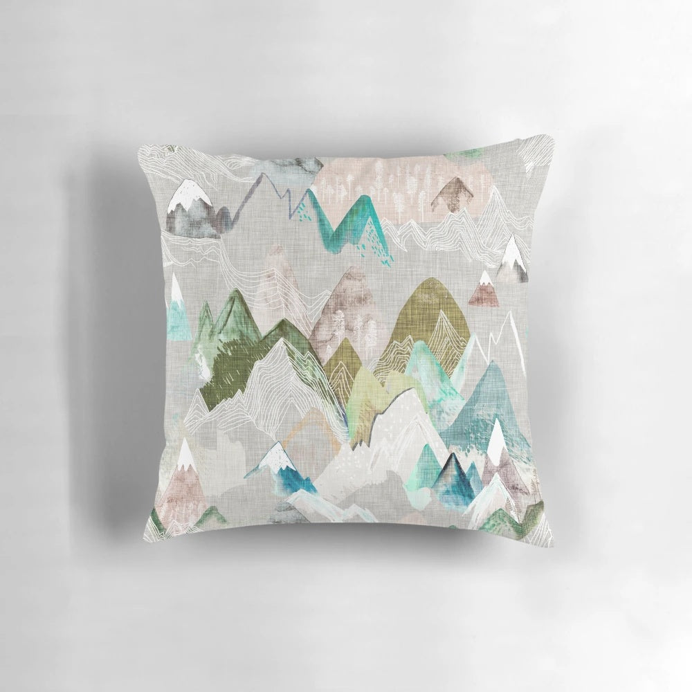 A watercolor-style pillow featuring a misty mountain range, perfect for nature-inspired home decor.