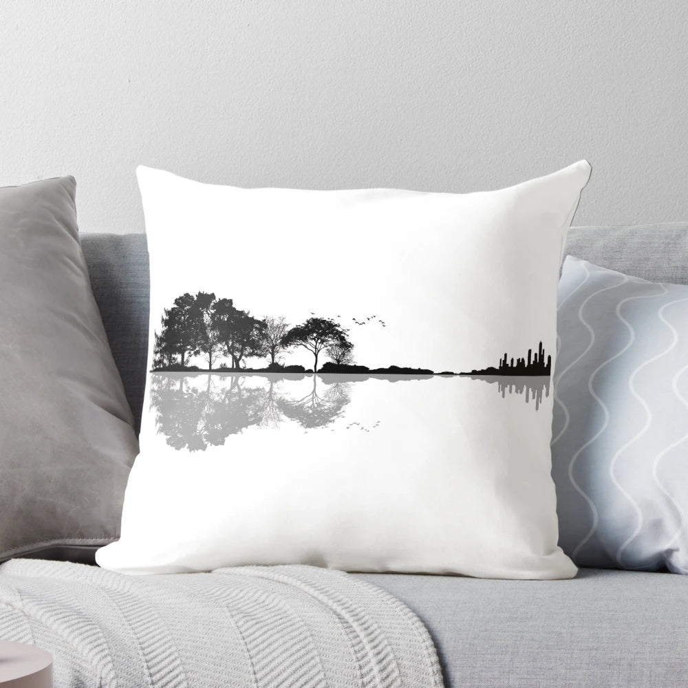 Artistic pillow design featuring a guitar silhouette against a nature landscape background