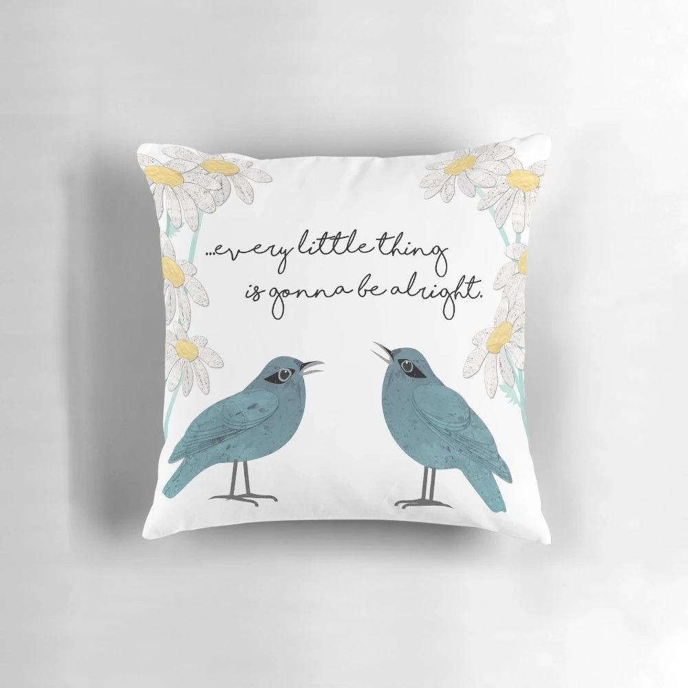 Decorative throw pillow featuring a collage-style design of birds, daisies, and nature-inspired elements in teal, blue, and green colors.