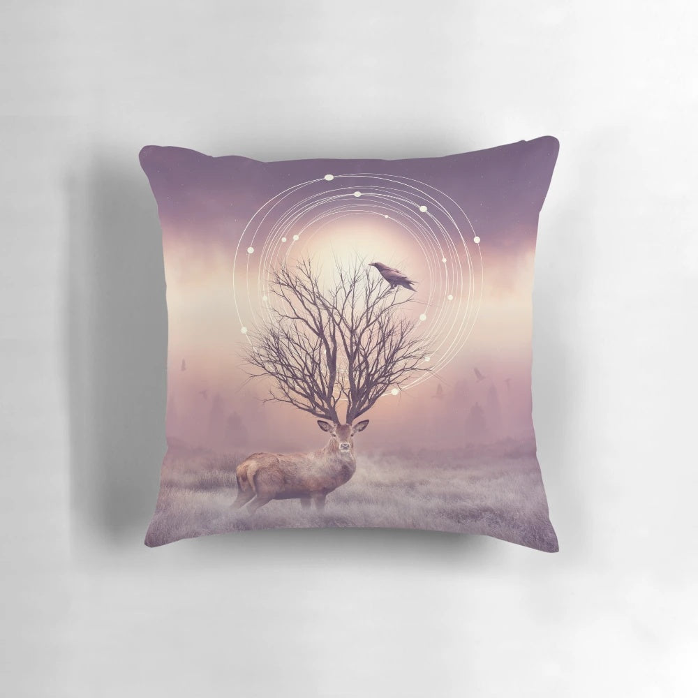 A pillow featuring a peaceful winter landscape with deer, birds, and tree branches against a backdrop of frost and stillness.