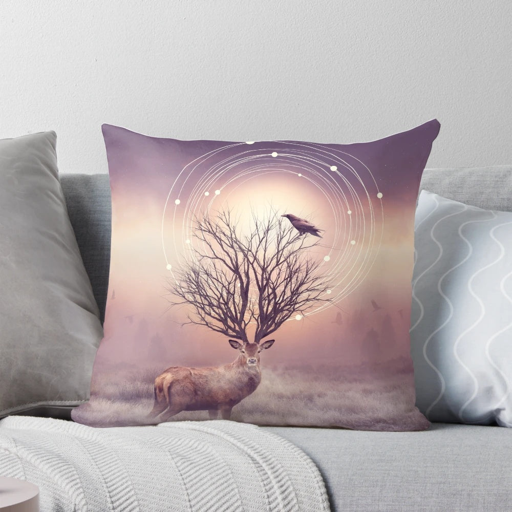 A pillow featuring a peaceful winter landscape with deer, birds, and tree branches against a backdrop of frost and stillness.