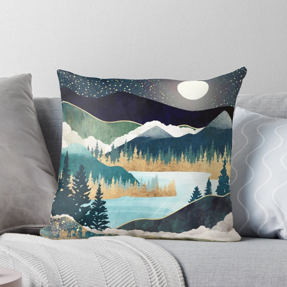 A tranquil pillow featuring a scenic landscape with a lake, mountains, and trees in shades of blue, teal, and green.