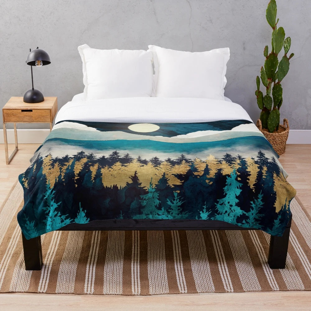 Plush blanket with abstract, nature-inspired design in shades of blue, green, and gold