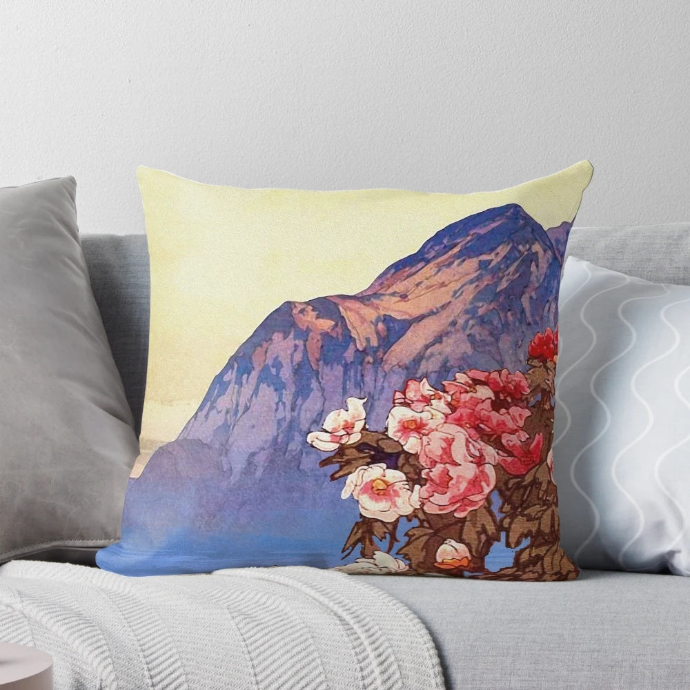 A cozy decorative pillow with a stunning nature landscape design featuring mountains, clouds, and colorful flowers.