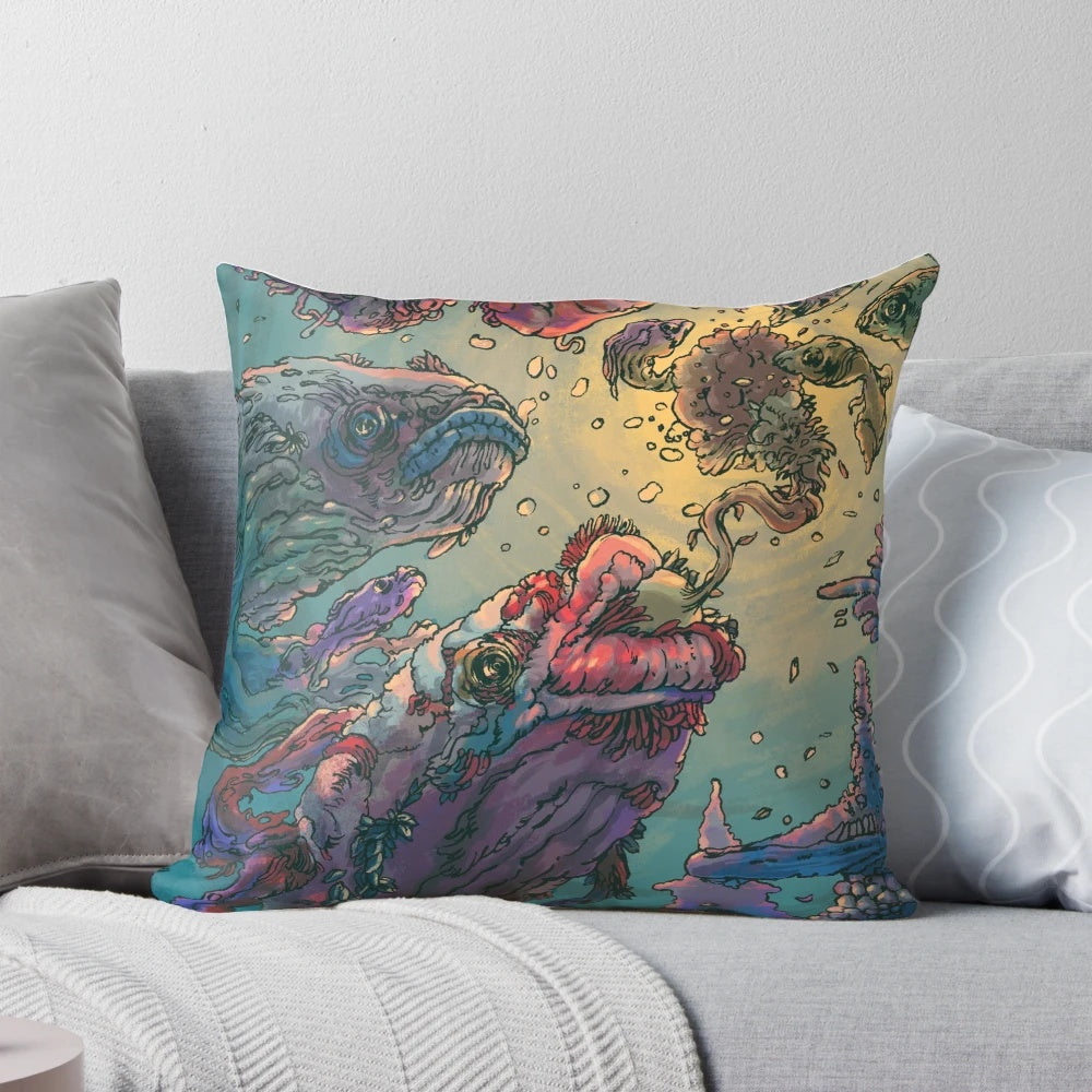 Decorative pillow featuring a vibrant underwater scene with fish, pearls, and a golden color palette